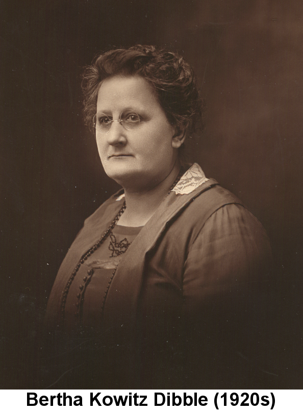 Sepia-tone photo of middle-aged Bertha Kowitz Dibble, dark curly hair worn short, with thin round wire-frame glasses and an elaborately decorated dress with white lace on the back of the collar.
